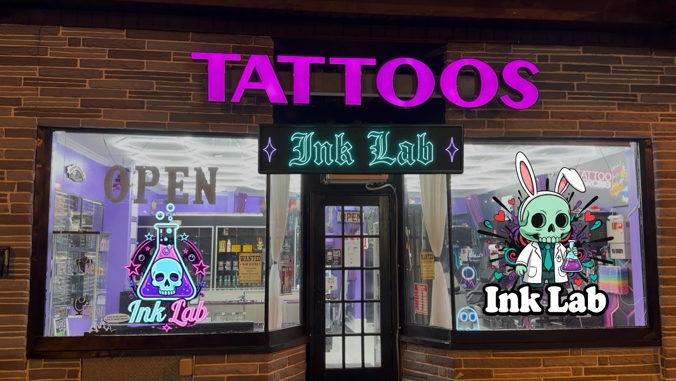 Ink Lab storefront at night with the TATTOOS neon sign and glowing windows